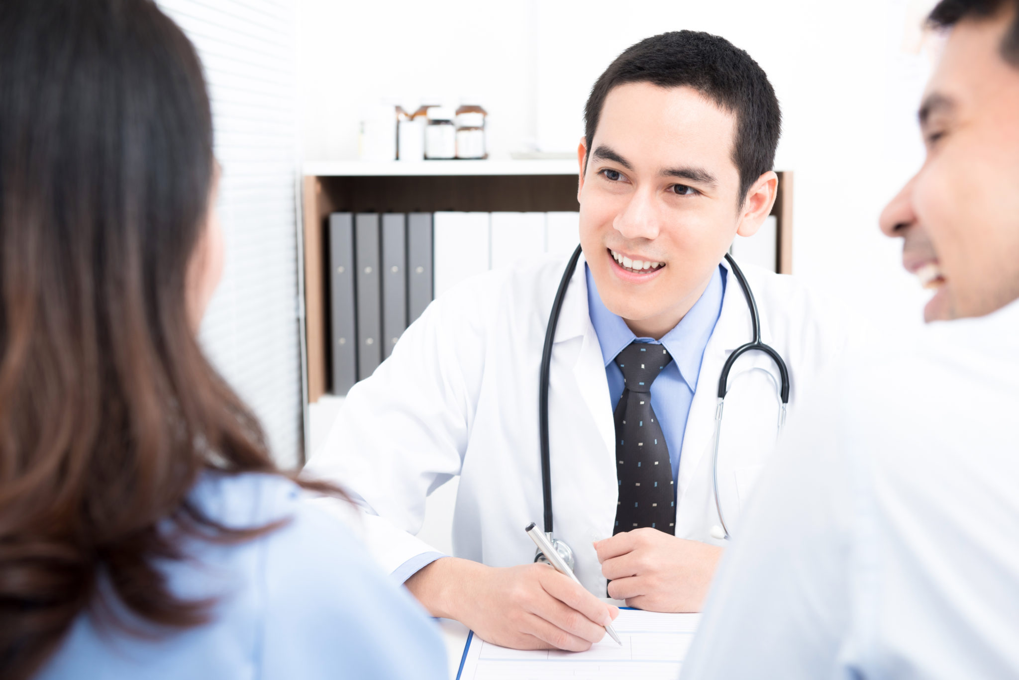 Doctor Consulting With Young Couple Patients