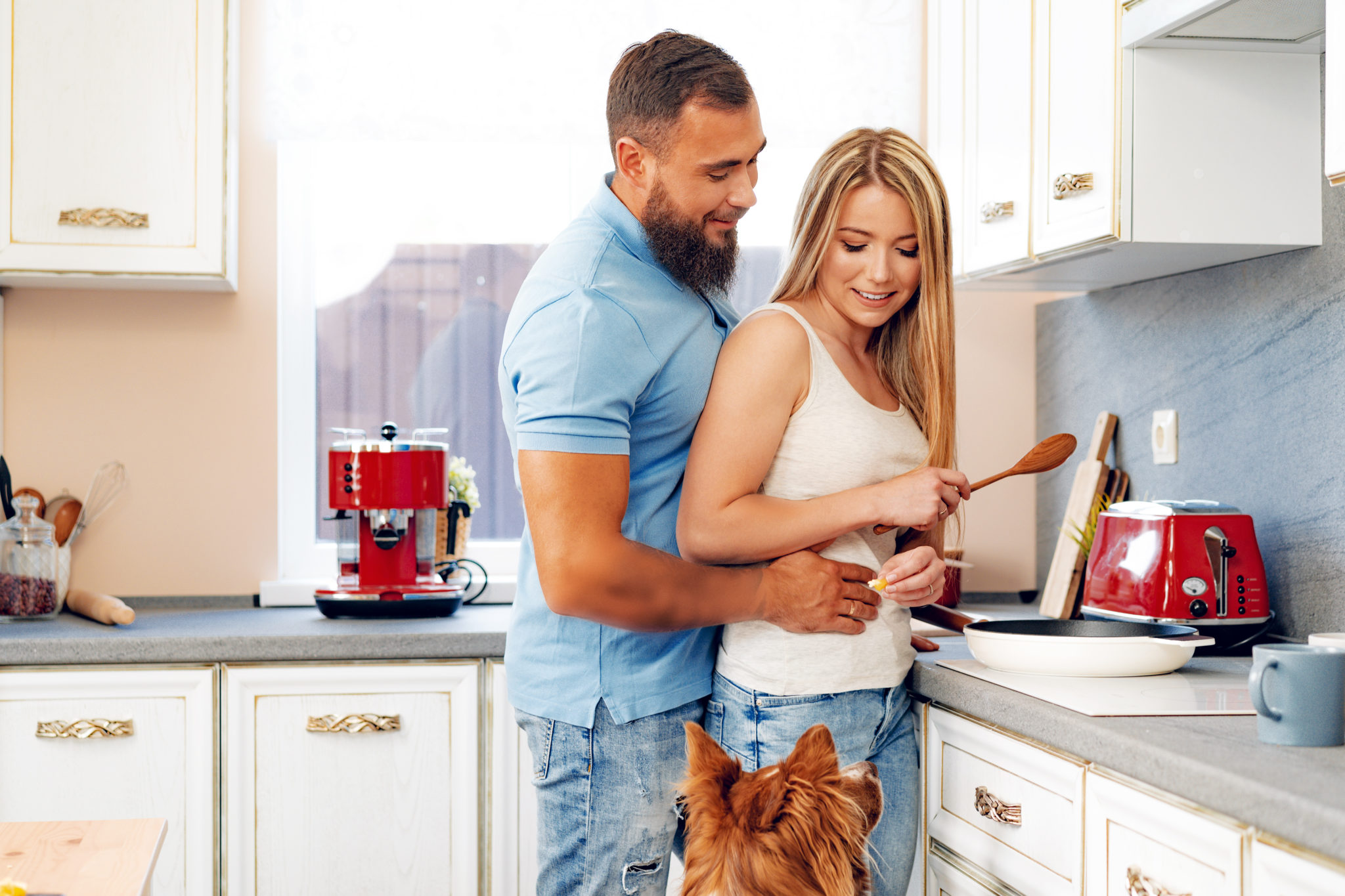 Young Loving Couple Cooking Together In Kitchen