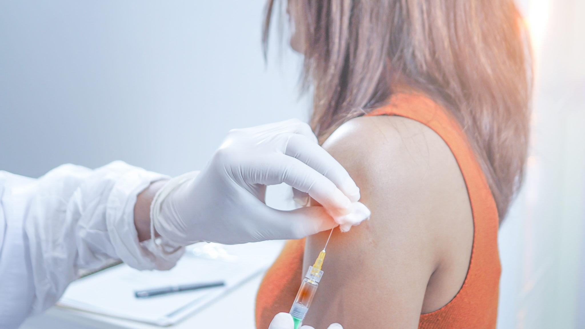 The Doctor Wears White Gloves Holding Syringe He Is Injecting Vaccination For Young Women Concept Prevent Hpv Infection By Vaccination Before Getting Infected